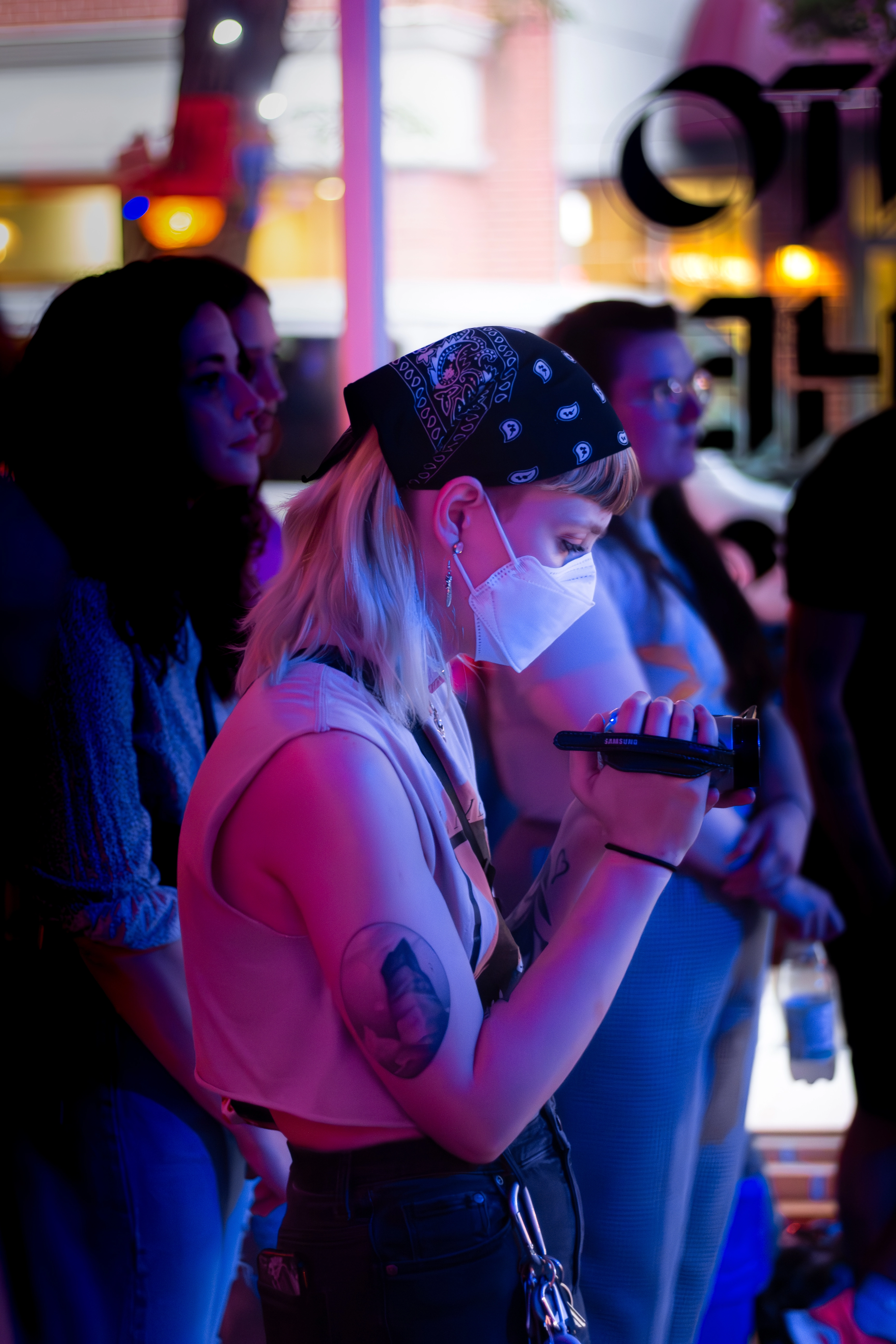 Picture of a person filming at a concert with a vintage video camera